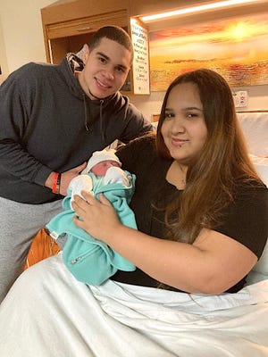 Kevin Rodriguez and Lyann Vega-Santiago of Marshall pose with their daughter, Kailani Zoe Rodriguez, who was born Jan. 1, 2022 at Oaklawn Hospital.
