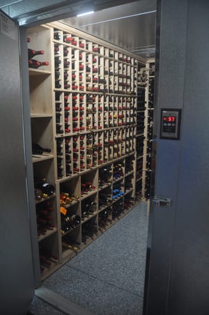 A temperature controlled wine safe is one of the features the homeowner added to the new house.