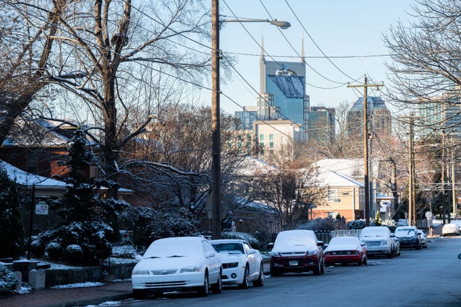 Snow covers the cars on the street in East Nashville, Tenn., Monday, Jan. 3, 2022. 