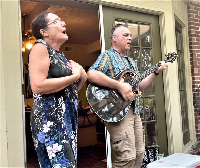 Corine Samwell and Marc Wise sing French songs at an outdoor meeting of L'Alliance Francaise during Bastille Day, 2021.