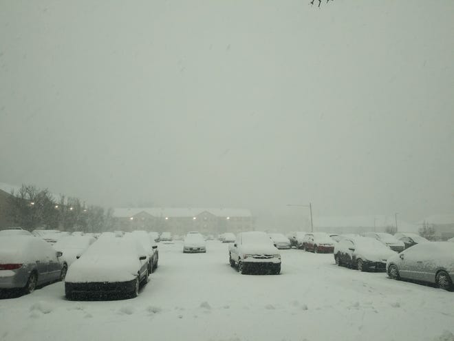 A row of cars covered in snow are parked at Premier Village Apartments in Dover around 9:30 a.m. Monday morning, during the state’s first snowfall of the year on Monday, Jan. 3, 2022.