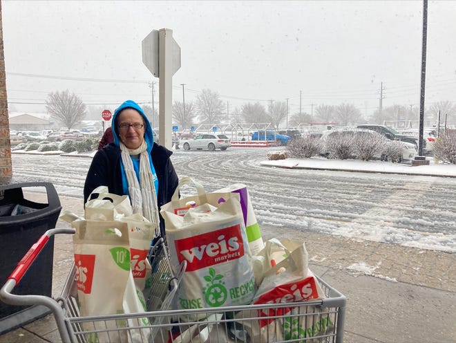 Lewes resident Dee Schuler is pictured outside of the Weis Market in Lewes as road conditions worsen in the nearby parking lot on Monday, Jan. 3, 2022.