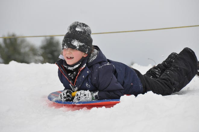 Andrew Van Arsdall sleds down the hill at the Smyrna-Clayton Little League Park on Duck Creek Parkway Jan. 3, 2022. About 8.5 inches of snow fell in the area.