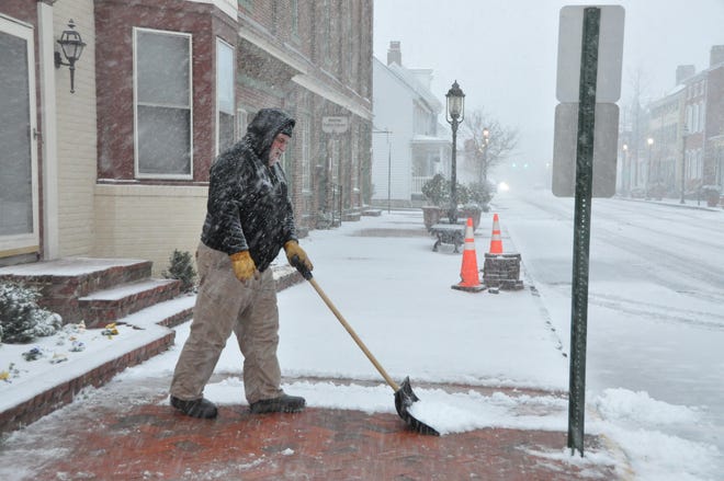 Kevin Fox from the Town of Smyrna crew shovels snow on South Main Street near the Smyrna Public Library at about 8:10 a.m. on Monday, Jan. 3, 2022.