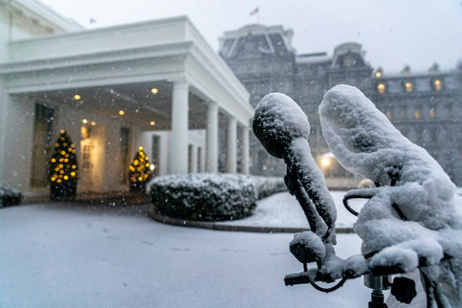 Snow falls at the West Wing of the White House in Washington, Monday, Jan. 3, 2022.