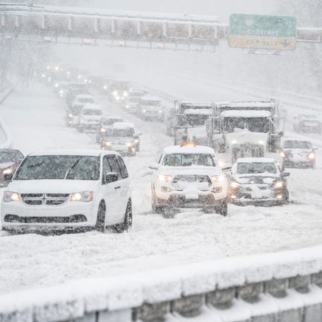 Traffic at a standstill as cars are stuck in heavy snow on the Theodore Roosevelt Bridge heading intro Virginia from DC as a winter storm dumped heavy snow across the South and mid-Atlantic on Monday, Jan. 3, 2022.