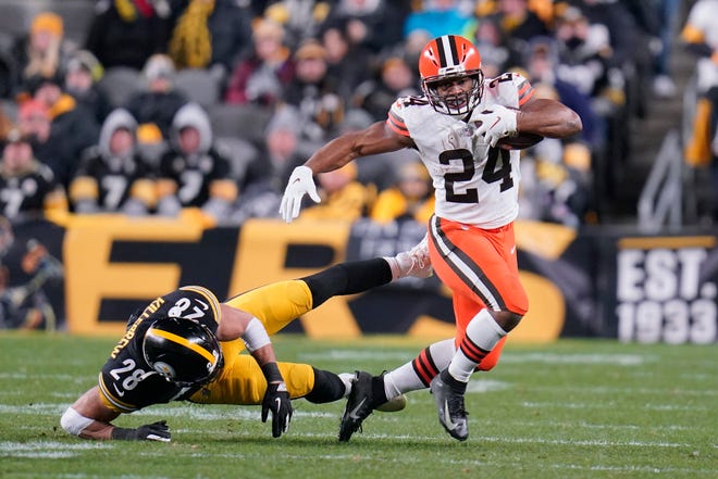 Cleveland Browns running back Nick Chubb (24) breaks a run away from Pittsburgh Steelers safety Miles Killebrew (28) during the second half an NFL football game, Monday, Jan. 3, 2022, in Pittsburgh. (AP Photo/Gene J. Puskar)