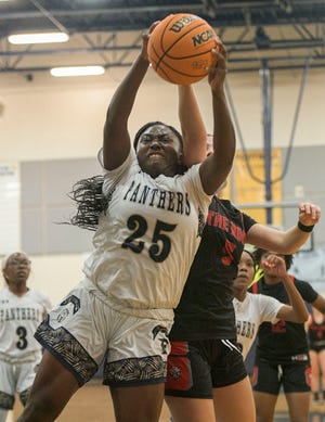 Eustis’ Tanaujeah Brown (25) pulls down a rebound during Monday's game against Gainesville The Rock at the Panther Den in Eustis. [PAUL RYAN / CORRESPONDENT]
