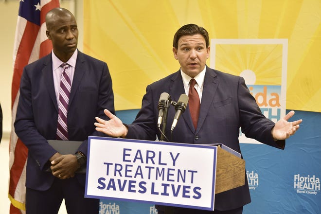 Florida Gov. Ron DeSantis, seen with Dr. Joseph Ladapo, Florida's surgeon general, addresses a question during a Jan. 4 news conference in Jacksonville to discuss COVID-19 testing policy and monoclonal antibody treatment availability.