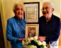 Roland and Faye Lanier hold their wedding photograph from 75 years earlier at a party one year ago.
