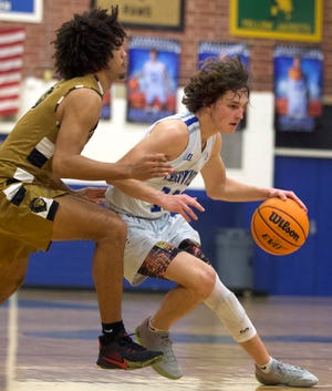 Cherryville's Carson Kelly dribbles past a Shelby defender during their December 2021 matchup.