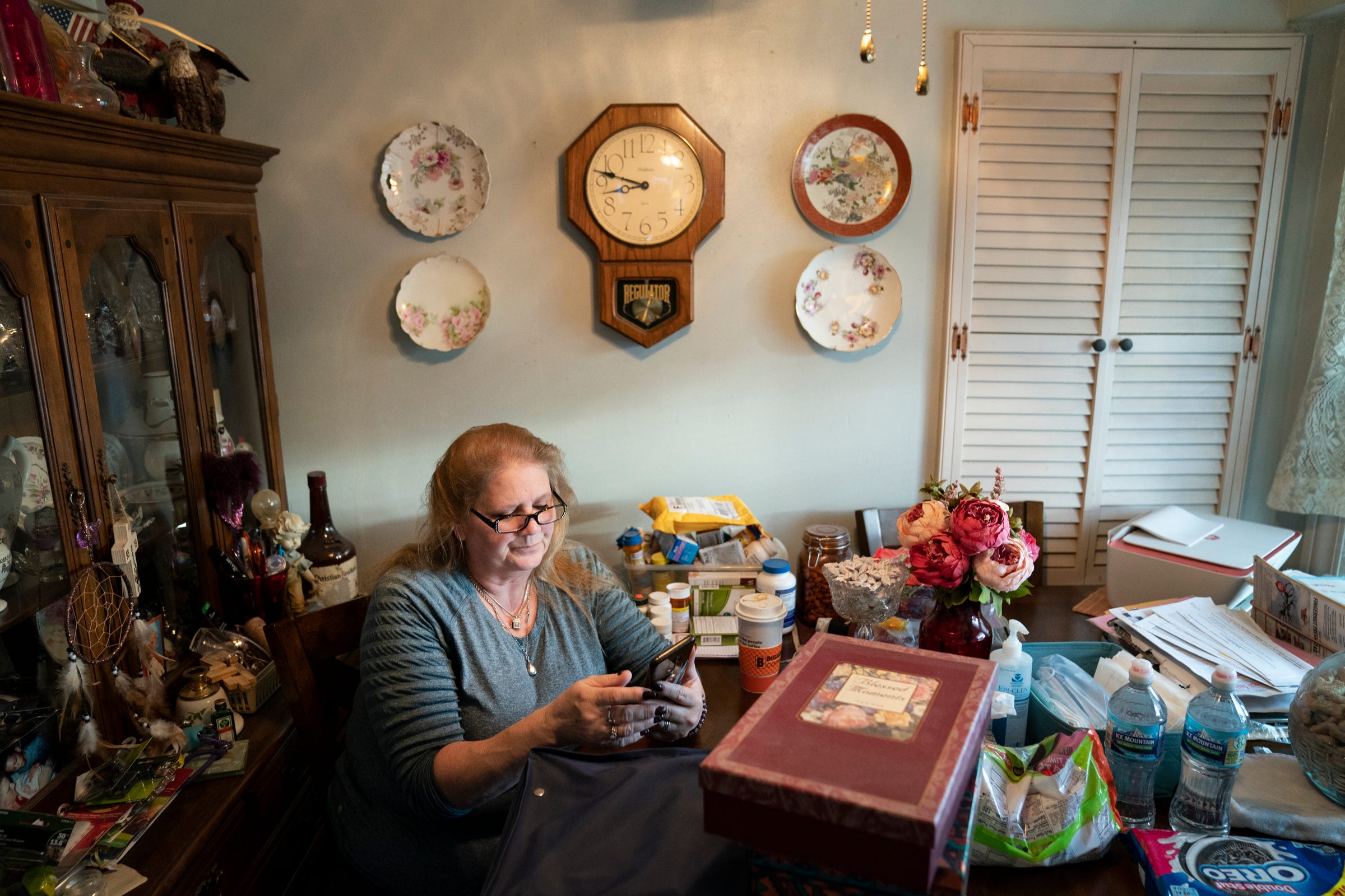 Kathi Kuykendall looks through family photos at her home in Allen Park.