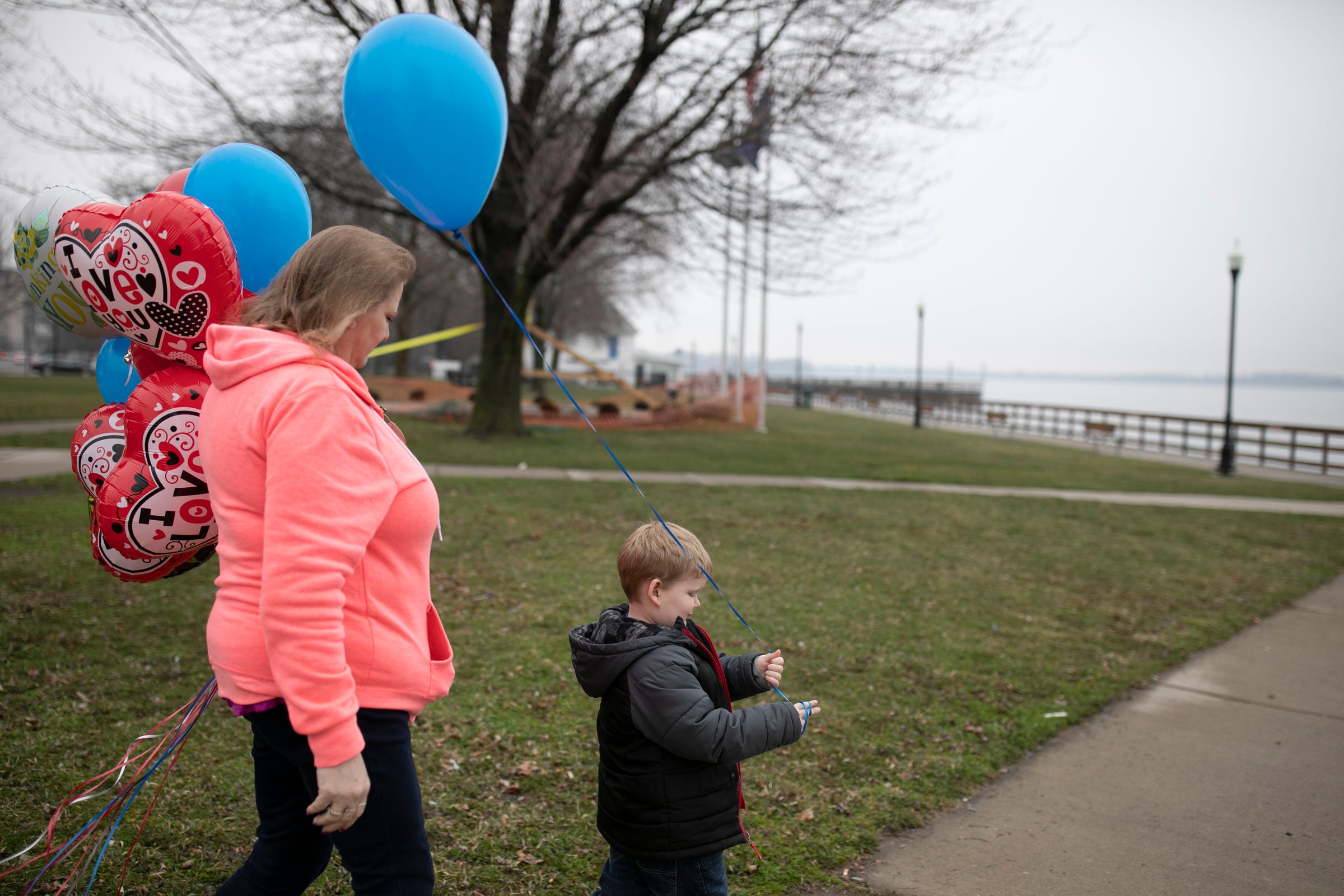 To mark the one-year anniversary of his death, Kathi Kuykendall and grandson Kamryn Olsen walk to the edge of the Detroit River in Wyandotte to release balloons in honor of Asa Kuykendall.