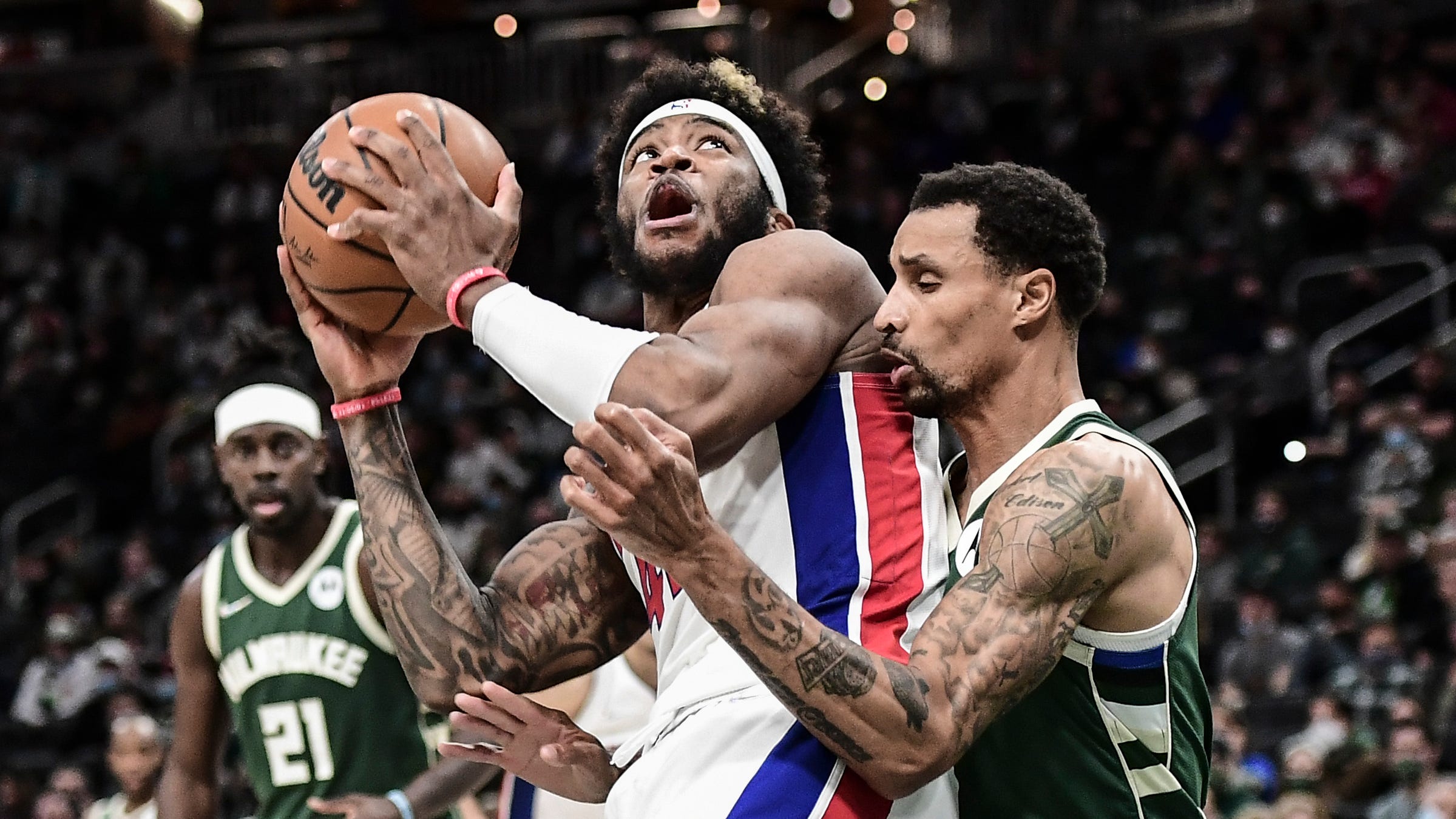 Pistons forward Saddiq Bey looks for a shot against Bucks guard George Hill in the fourth quarter of the Pistons' 115-106 win on Monday, Jan. 3, 2022, in Milwaukee.