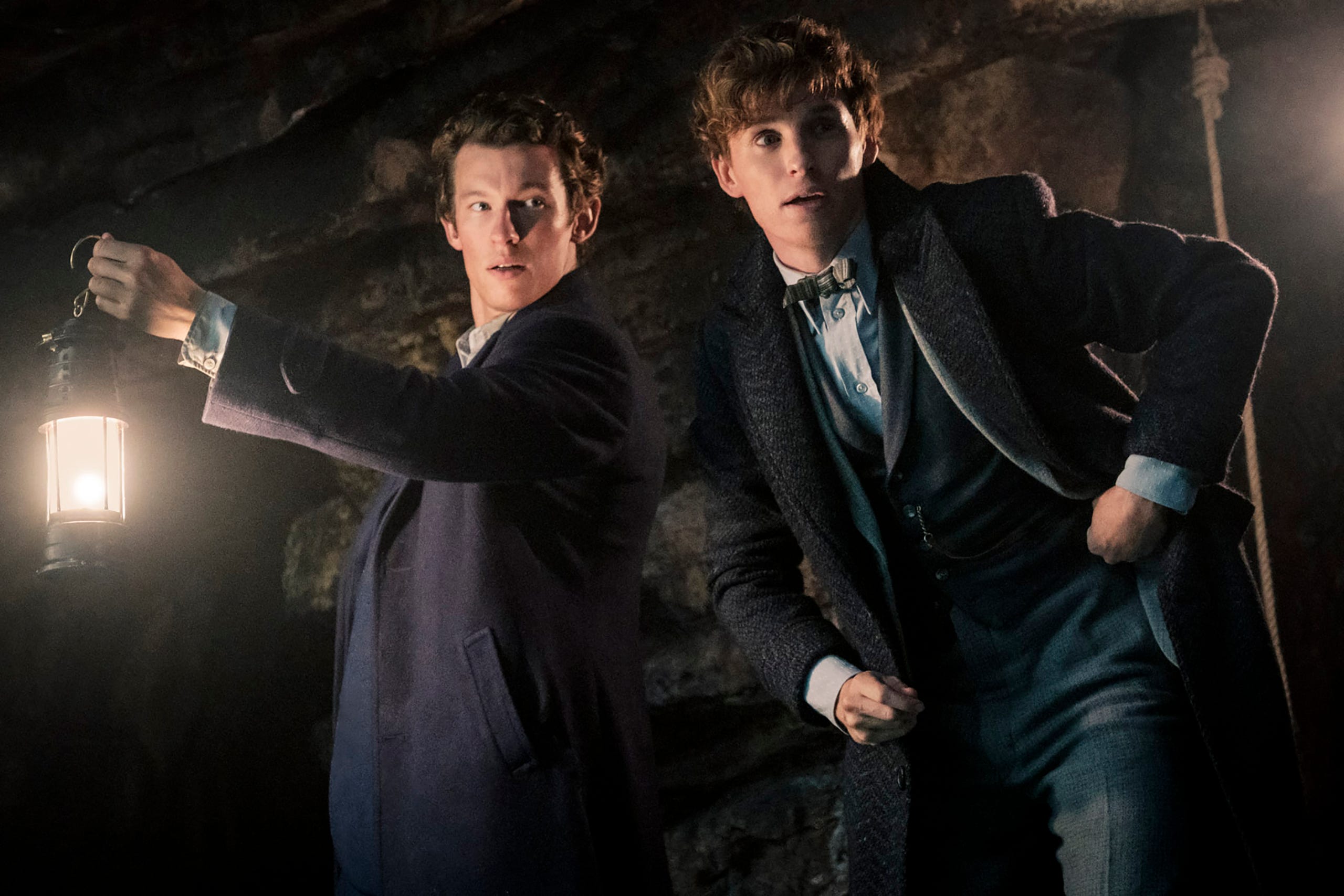 Newt Scamander (Eddie Redmayne, right) and his brother Theseus (Callum Turner) are on a mission to fight back against a dark wizard's power play in "Fantastic Beasts: The Secrets of Dumbledore."