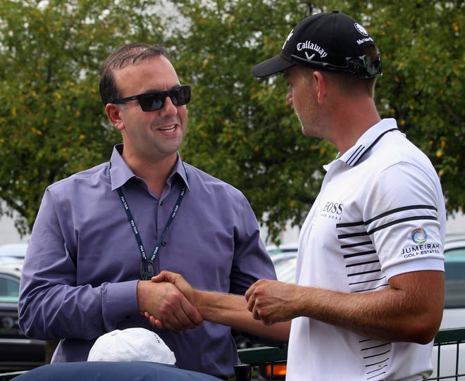 Sports agent RJ Tiger talks with Henrik Stenson during a Bridgestone invite at Firestone Country Club in Akron.  Nimr has been appointed as the new dean of the University of Akron School of Business.