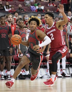 Ohio State Buckeyes guard Meechie Johnson Jr. (0) drives around Wisconsin Badgers guard Jordan Davis (2) during the second half of the NCAA men's basketball game at Value City Arena in Columbus on Saturday, Dec. 11, 2021.