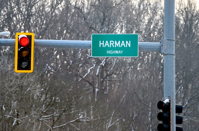 A street sign at Illinois Route 116 and Airport Road carries the spelling "Harman Highway."