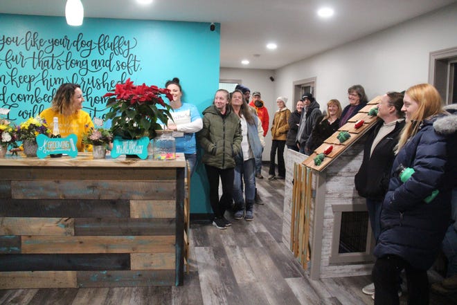 Community members gather at Perry Paw Spa for a ribbon cutting ceremony on Tuesday, Jan. 4.