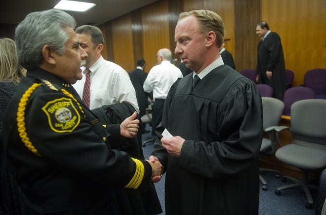 Judge Michael Mulvihill, right, after being sworn in in 2015. Mulvihill faced public censure by a judicial misconduct commission in October following a DUI crash and what the commission described as misleading statements to police officers.