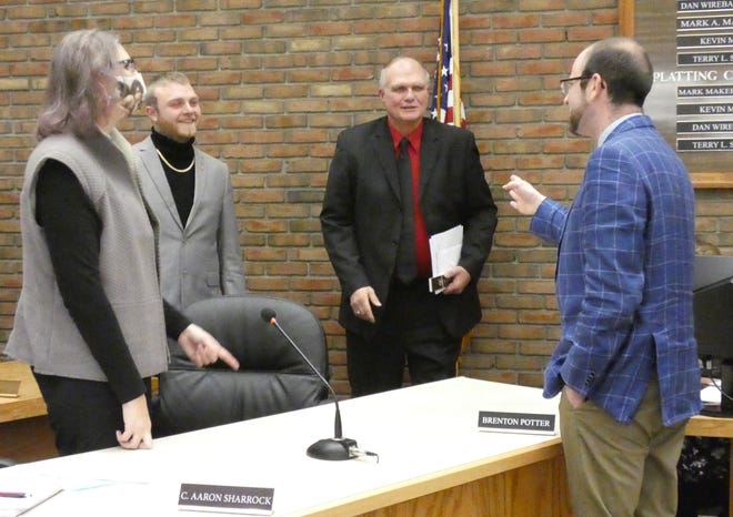 Brian Gernert, Bucyrus law director, right, congratulates departing First Ward council representative Bruce Truka after the 2019-2021 council concluded its sine die session Tuesday night. From left are C. Aaron Sharrock, D-Second Ward, and incoming First Ward representative Brenton Potter.