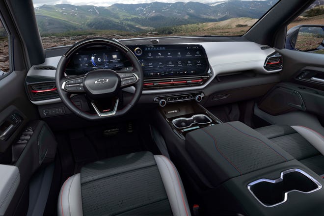 The 2024 Chevrolet Silverado EV RST's interior features large 11-inch and 17-inch screens, 7 gallons of center console storage, and the ability to self-drive SuperCruise.