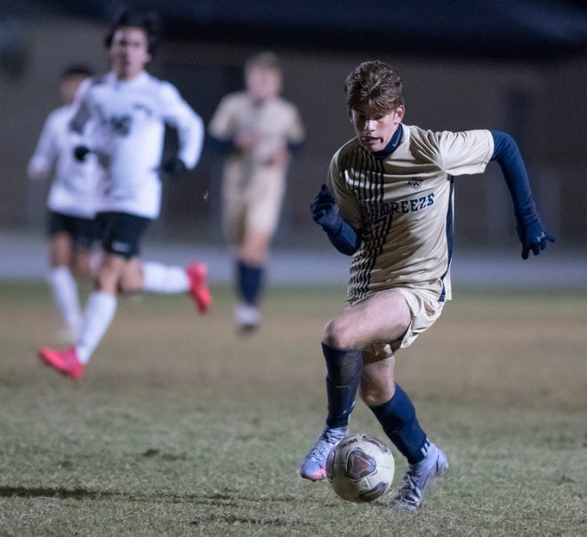 Will Woodward (9) controls the ball during the West Florida vs Gulf Breeze boys soccer game at Gulf Breeze High School on Tuesday, Jan. 4, 2022.