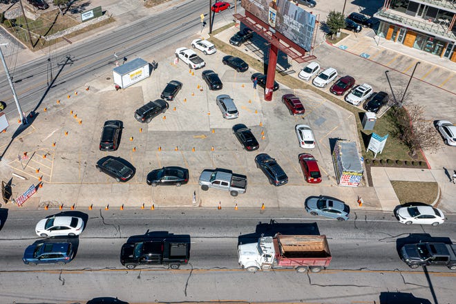 Vehicles line up at a COVID-19 testing site on South Lamar in Austin, Texas on Jan. 6, 2022. Austing recently moved back into Stage 5COVID-19 protocols after a spike in positive cases and hospitalizations.