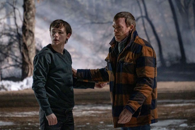 Harrison (Jack Alcott), left, and Dexter (Michael C. Hall) share a father and son moment after both of them were nearly killed in the woods. The scene was filmed off Harvard Road in Lancaster.