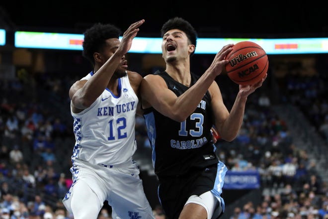North Carolina’s Dawson Garcia, right, drives on Kentucky’s Keion Brooks Jr. last month at T-Mobile Arena in Las Vegas.