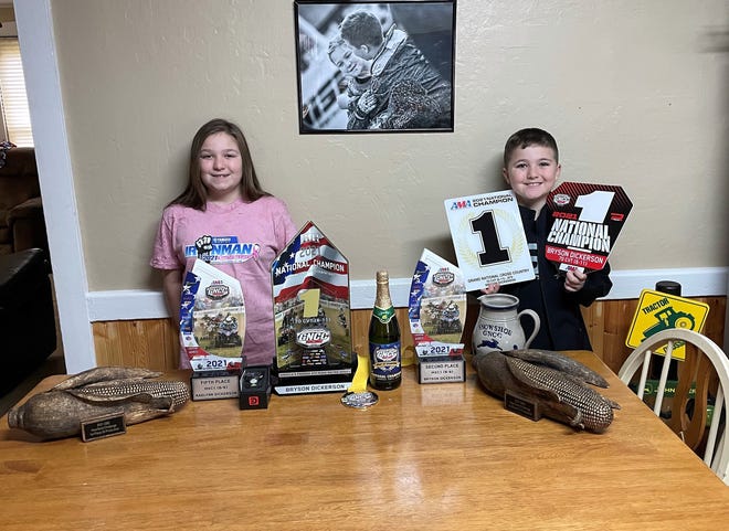 Raelynn and Bryson Dickerson with some of the awards they've collected over the 2021 season of the Grand National Cross Country national competition of ATV racing.