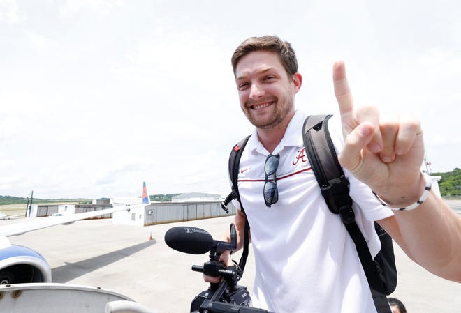 Former Ball State wide receiver and current Alabama senior broadcast producer/editor Aaron Hepp boards a plane. Hepp, an Indianapolis native, will return to Lucas Oil Stadium for the 2022 College Football Playoff National Championship.