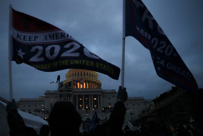 A mob of Trump supporters climbed scaffolding and took to the steps of the U.S. Capitol building in Washington on Jan. 06, 2021. Rioters breached the building following a rally, as Congress was preparing to certify President Joe Biden’s victory.