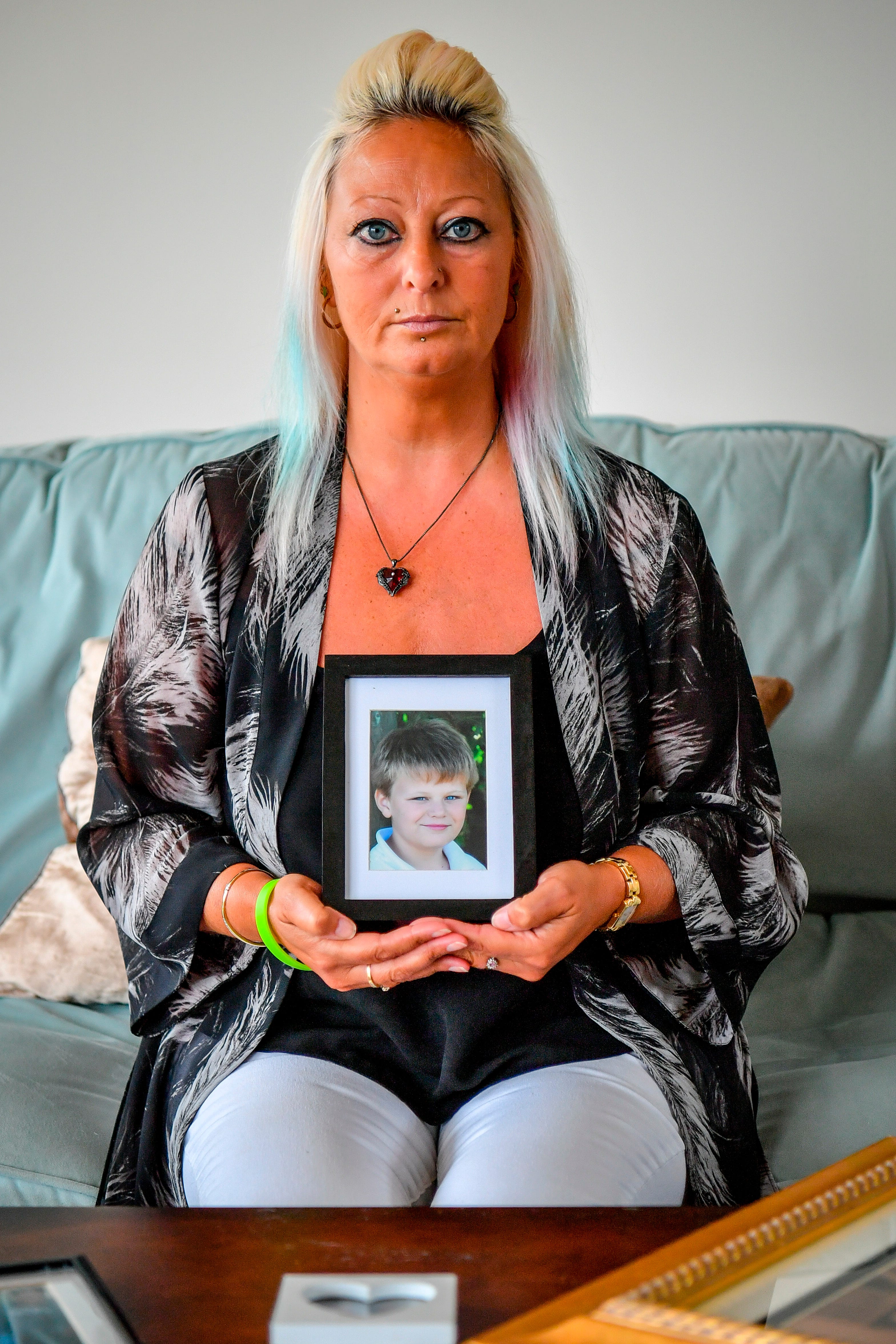 Charlotte Charles, mother of Harry Dunn, holds a photograph of Harry at 14 years old. Dunn, 19, was killed when his motorbike crashed into a car being driven on the wrong side of the road by American Anne Sacoolas.