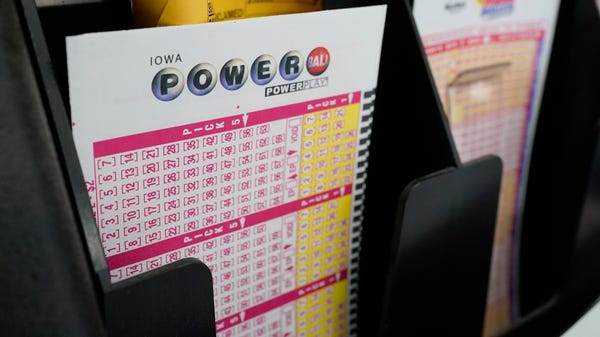 Blank forms for the Powerball lottery sit in a bin