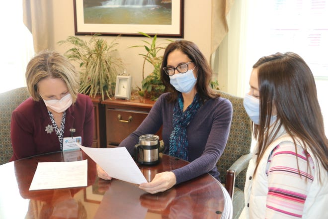 Conemaugh Health System staff members are shown wearing medical-grade masks in a meeting. Pictured are, from left to right: Dr. Elizabeth Dunmore, Leanne Zdravecky and Amy Oliveros.