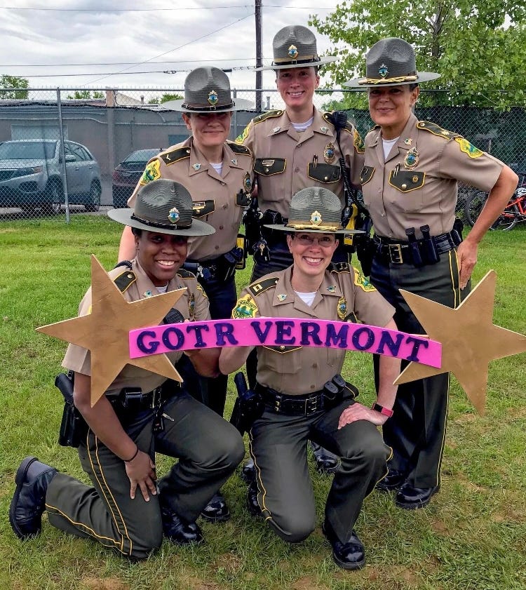 Vermont State Police women volunteered to help out during the Girls On the Run 5K in Essex in 2019. Captain Julie Scribner, who is pictured in the center holding the sign, coached young girls in the program.