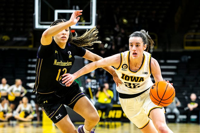 Iowa guard Caitlin Clark, right, drives against Northwestern guard Veronica Burton (12) during a NCAA Big Ten Conference women's basketball game, Thursday, Jan. 6, 2022, at Carver-Hawkeye Arena in Iowa City, Iowa.