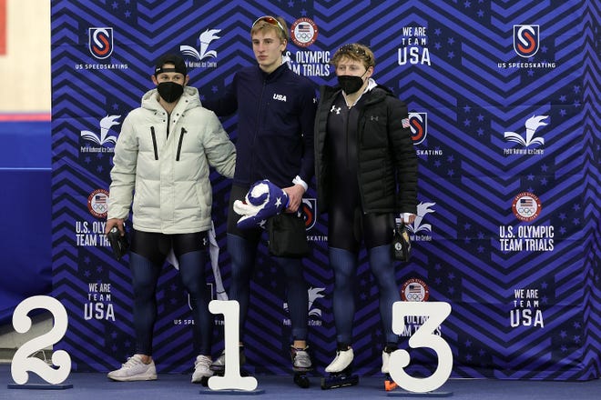 From left, runner-up Joey Mantia, winner Jordan Stolz and third-place finisher Austin Kleba share the podium after the men's 1,000 meters in the U.S. Olympic long-track speedskating trials Thursday night at the Pettit National Ice Center.