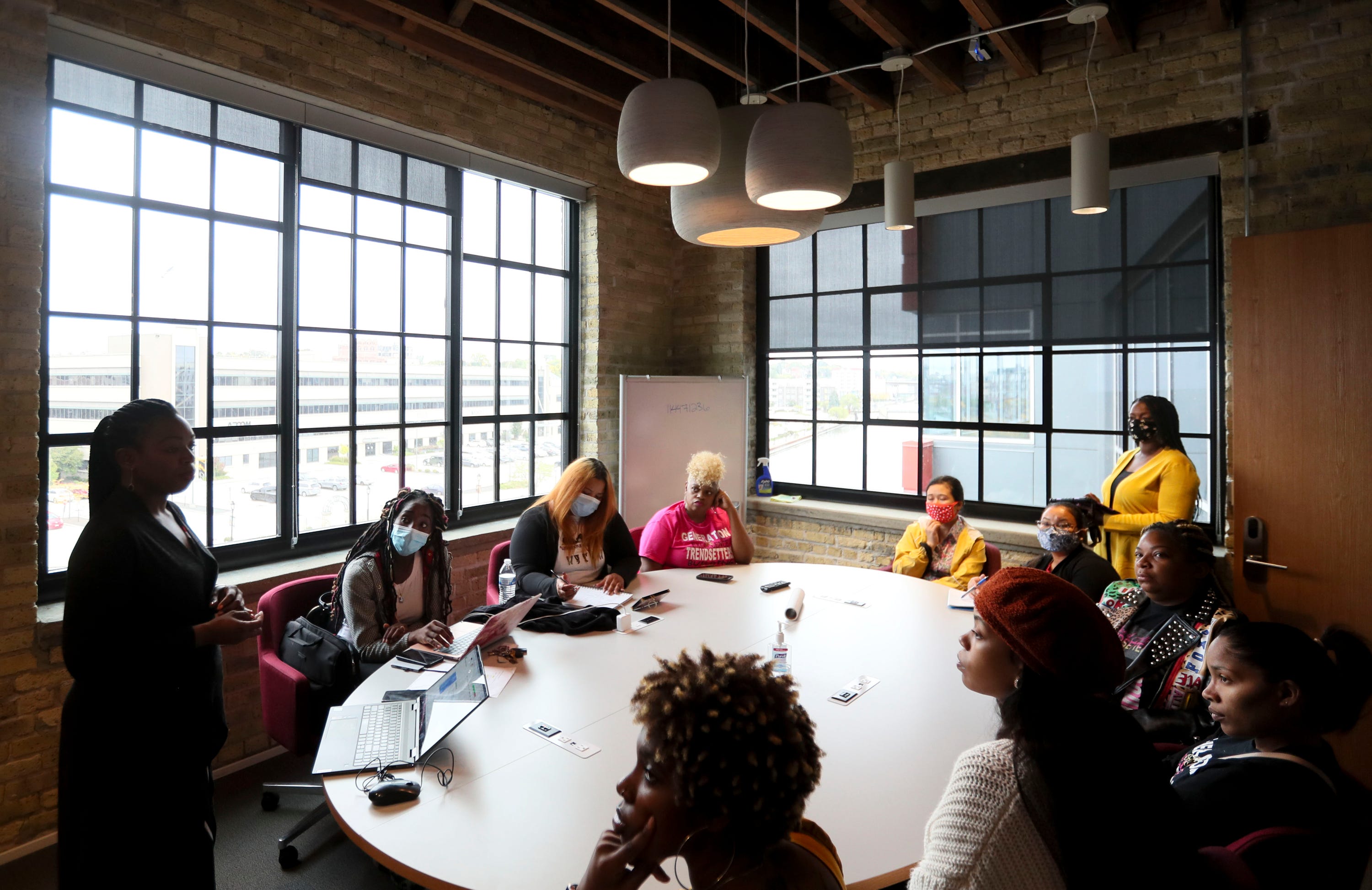 Bria Grant, UniteWI executive director, meets with owners and employees of several Milwaukee prenatal care coordination companies during an October training session. Grant has been urging state officials to step up oversight of the program.