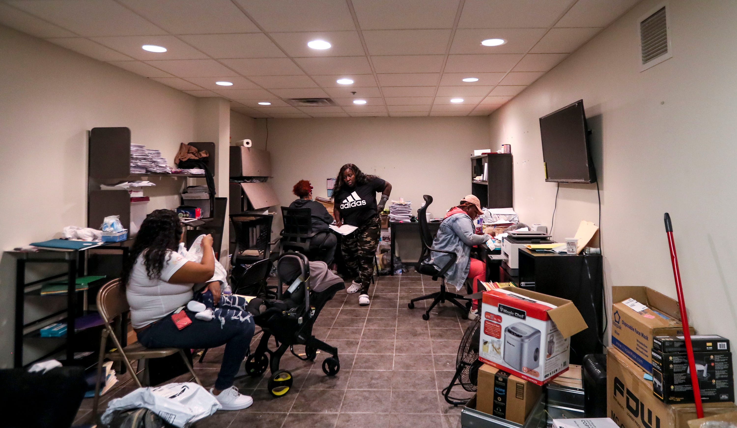 Several employees of Here For You Prenatal Coordination Services gather in the company's former office on North Richards Street in October. The following month, the state cut off Medicaid funding to the group.