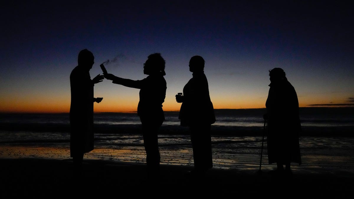A dawn ceremony organized by Gullah Geechee elder Sandra Boyd, also known as "Mama Sasa," at South Carolina's Hunting Island State Park on on Nov. 1, 2021, honors African ancestors who made the Middle Passage.