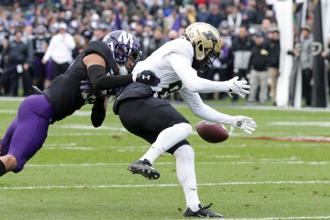 Purdue wide receiver TJ Sheffield (8) drops the pass as he is tackled by Northwestern safety Brandon Joseph (16) during the second quarter of an NCAA college football game, Saturday, Nov. 20, 2021 at Wrigley Field in Chicago.

Cfb Purdue Vs Northwestern