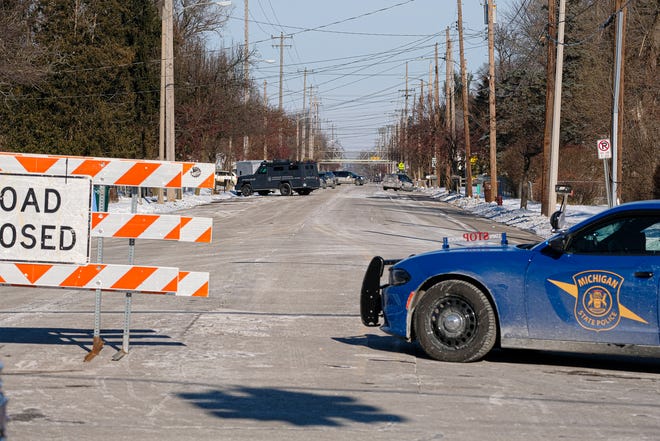Lansing police and Michigan State Police block off a stretch of Pleasant Grove Road from Holmes Road to Jolly Road because of a barricaded gunman Saturday, Jan. 8, 2022.
