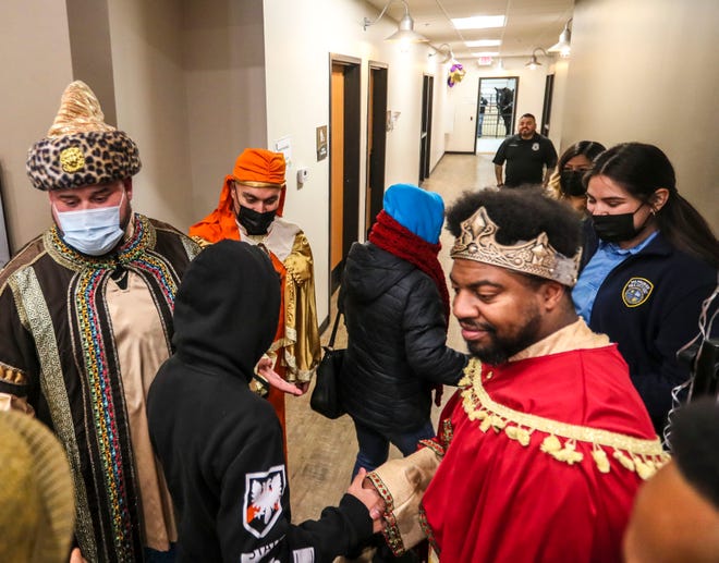 District 2 Police Officers Daniel Clifford, left, Jose Acevedo, middle, and Chris Greer, right, dressed as kings, greet families during the seventh annual Three Kings event Saturday, Jan. 8, 2022, at MKE Urban Stables in Milwaukee.