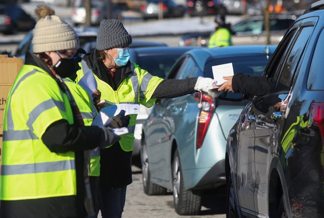 Cars receive one box each - two tests per box - as the New Castle County government distributes 6500 COVID rapid test kits at its Reads Way center near New Castle Saturday, Jan. 8, 2022.