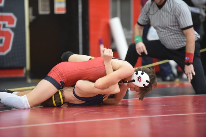 Clinton freshman Braylon Long works to pin Haslett's Ayden Fenby during their bout at the Dave Elliott Memorial Invitational, hosted by Clinton High School, on Saturday. Long won all three of his bouts via pinfall to take the 103-pound title and improve to 19-3 in his matches this season.