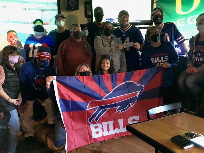 The Eugene Bills Backers club gives White Bird Clinic a donation before watching the game against the New York Jets on Sunday, Jan. 9, 2022.