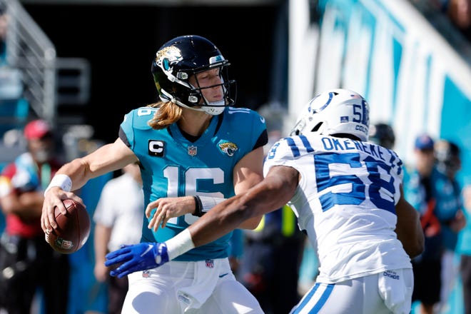Indianapolis Colts quarterback Bobby O'Kerik (58) presses on Jacksonville Jaguars quarterback Trevor Lawrence (16) as he looks for a future during the first half of an NFL football game, Sunday, Jan. 9, 2022, in Jacksonville, Florida.