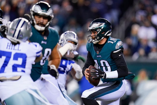Eagles quarterback Gardner Minshew runs with the ball during the first half of an NFL football game against the Dallas Cowboys, Saturday, Jan. 8, 2022, in Philadelphia. (AP Photo/Julio Cortez)